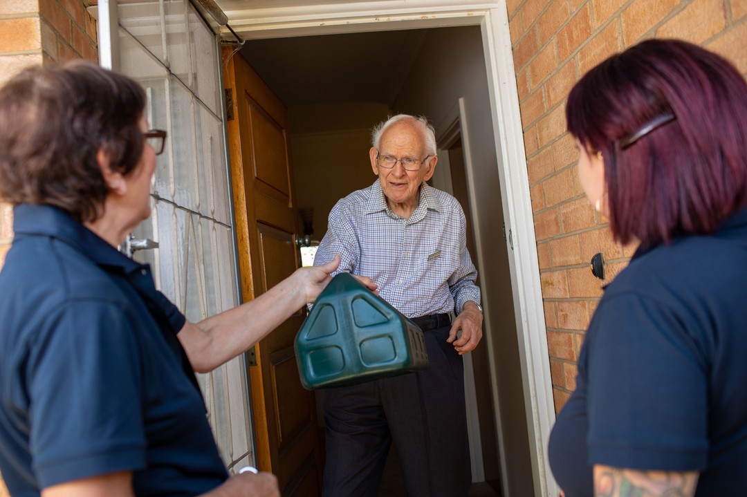 delivery drivers delivery food to elderly man