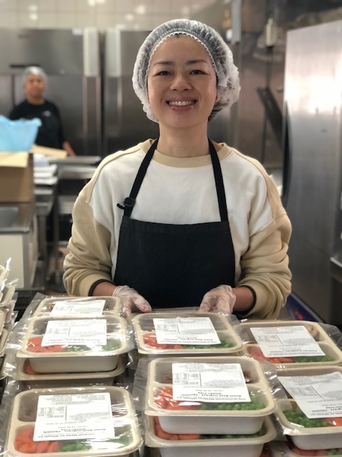 kitchen assistant packing meals